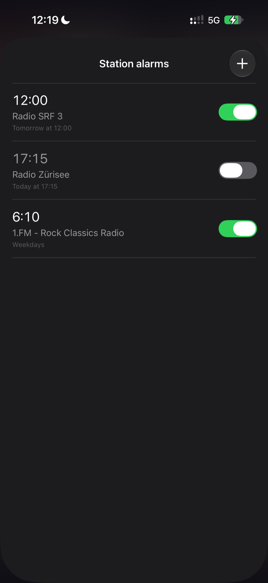 The station alarms list on iPhone: three alarms, each with a time, a radio station and a repeat schedule, two of them switched on.
